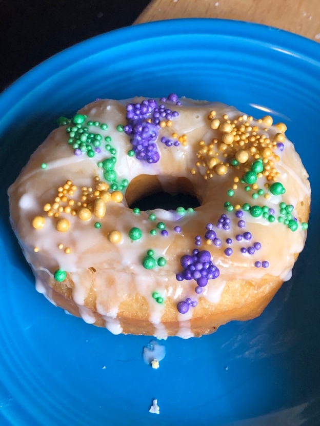 A donut with sprinkles on it

Description automatically generated