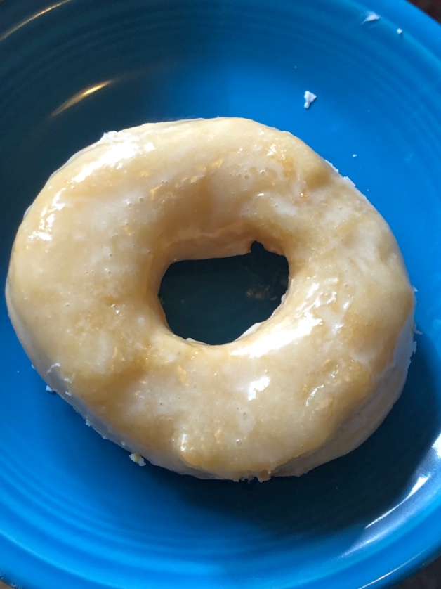 A donut on a plate

Description automatically generated